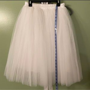 White ballerina skirt, adjustable elastic around top, fits multiple